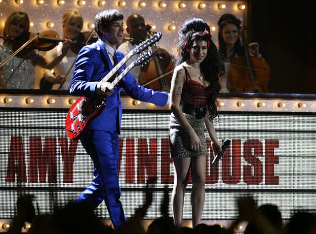Mark Ronson performing on stage with Amy Winehouse at the 2008 Brit Awards