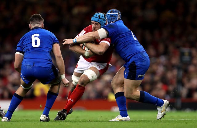 Italy's Luca Bigi, right, tackles Wales forward Justin Tipuri