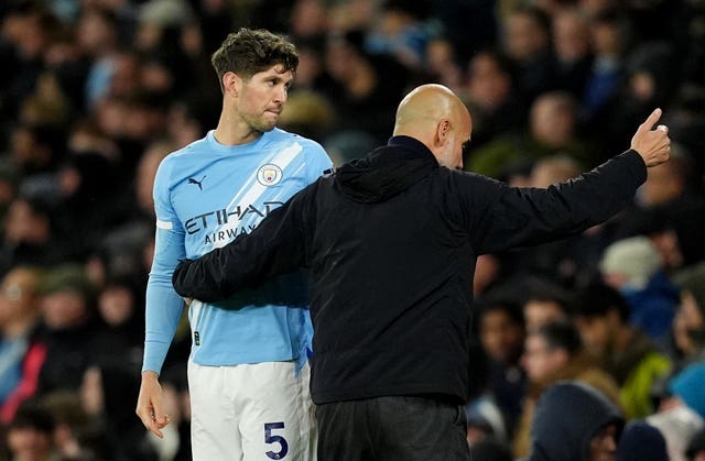 Manchester City manager Pep Guardiola embraces John Stones