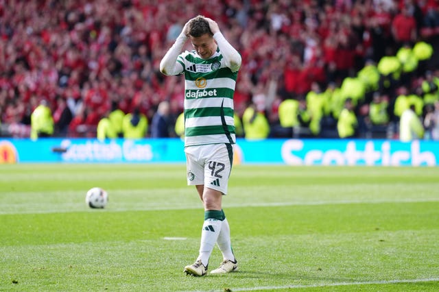 Callum McGregor has his head in his hands after seeing his penalty saved