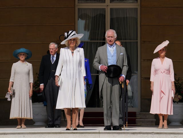 Charles and Camilla stood with other family members as they listened to the National Anthem