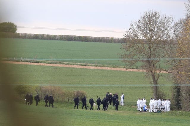 Police forensic and specialist search officers gather near the scene at Akholt Wood, close to the hamlet of Snowdown, near Aylesham, Kent, where the body of PCSO Julia James was discovered