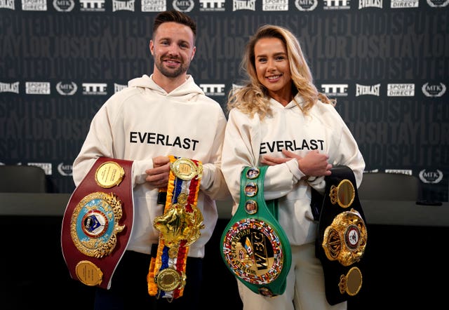 Boxer Josh Taylor, who is undisputed light-welterweight champion, shows off his belts at the new Sports Direct flagship store on Oxford Street, London, alongside his partner Danielle Murphy