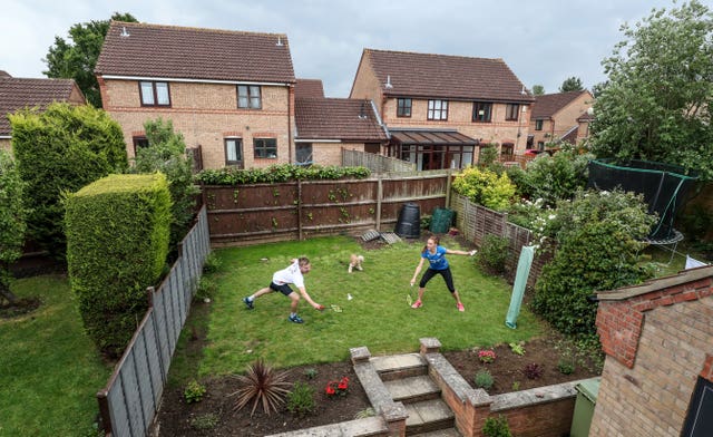 British badminton players Lauren Smith and Marcus Ellis practise in the back garden of their Milton Keynes home. The couple, who won silver in the mixed doubles at the 2018 Commonwealth Games in Australia, were forced to improvise in order to keep in shape during lockdown.