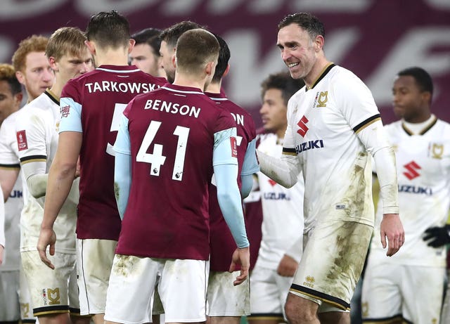 Richard Keogh, right, congratulates the Burnley players after their shootout win