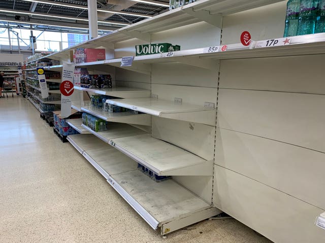 Empty shelves in the water aisle of the Tesco store at St Rollox in Glasgow (Andrew Milligan/PA)