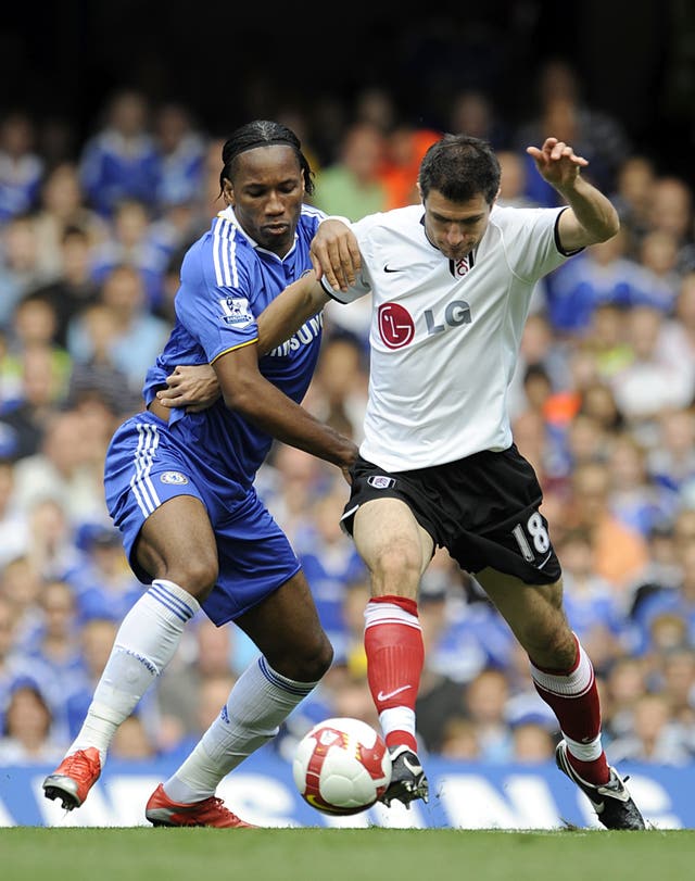 Drogba and Hughes battle for the ball during their playing days