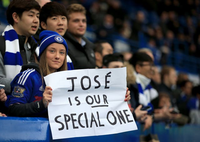 A Chelsea fan in the stands with a banner in support of Jose Mourinho