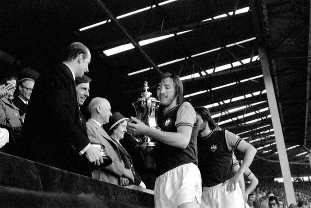 West Ham captain Billy Bonds lifts the FA Cup trophy at Wembley