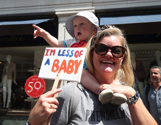 A baby with a banner during a protest of Donald Trump's trip to the UK