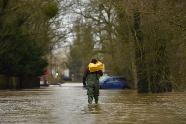 A man wades through floodwater in Upton-upon-Severn, Worcestershire