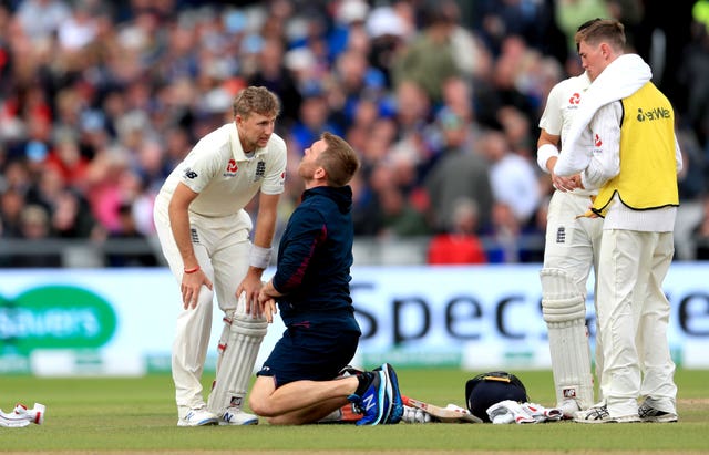 England's Joe Root receives medical treatment after being hit in the box