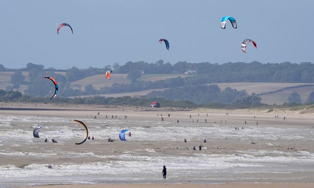 Kite surfers on a beach