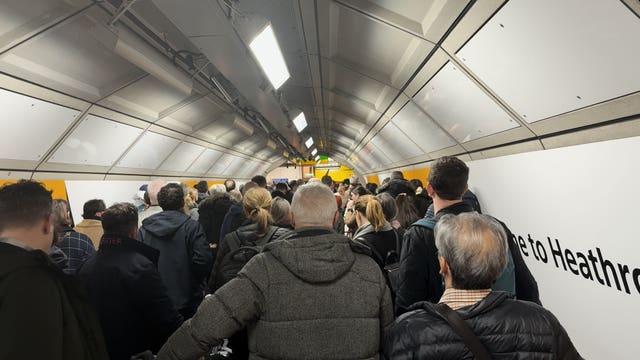 Elizabeth line passengers queuing to exit Heathrow T2/3 station