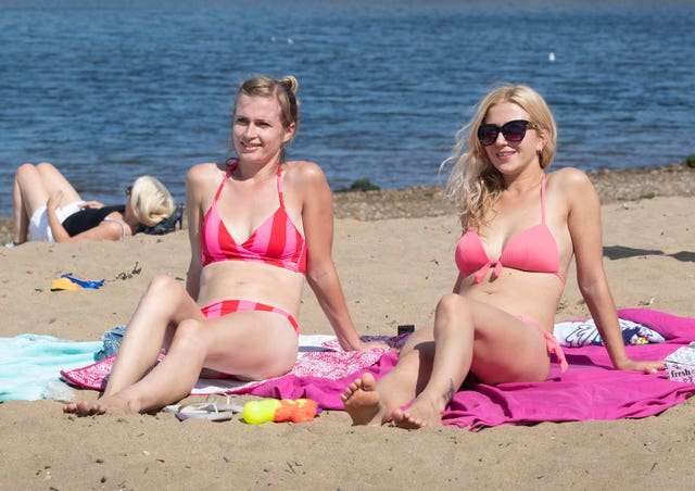 Sunseekers at Whitby in Yorkshire, enjoying the hot bank holiday weather (Danny Lawson/PA)