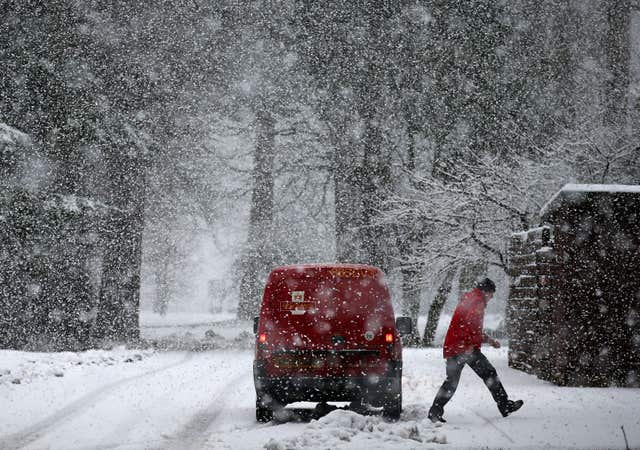 A postman delivers mail in blizzard conditions near Doune, Central Scotland, as the Met Office has issued an amber 
