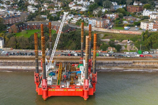 A huge construction machine at Dawlish train station where work has begun building a new and bigger sea wall to protect the railway and town from rising sea levels