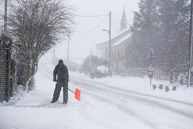 A man clears the snow near County Durham (Owen Humphreys/PA)