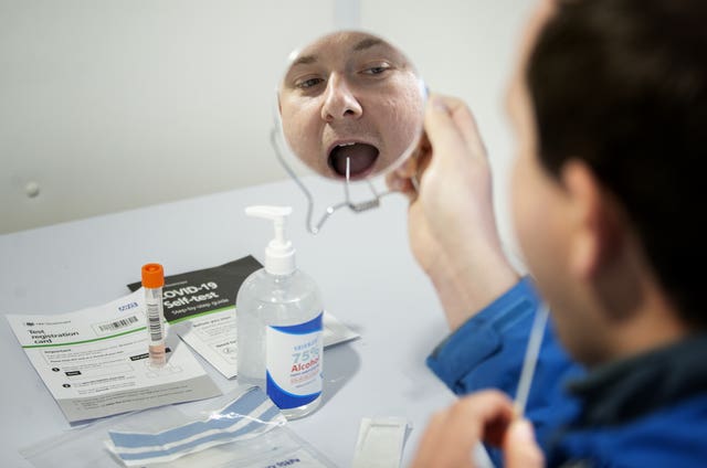 Andrew Ilesley demonstrates how to use a self-test kit at the new walk-through Covid-19 testing centre in Dundee in October