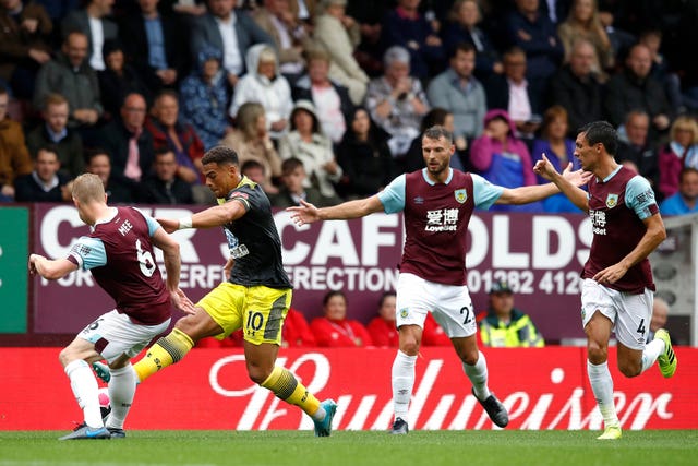 Che Adams, second left, challenges Burnley’s Ben Mee