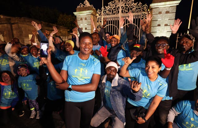 Monica Pumpkin with fellow Sanctuary Runners after presenting President Michael D Higgins with flowers