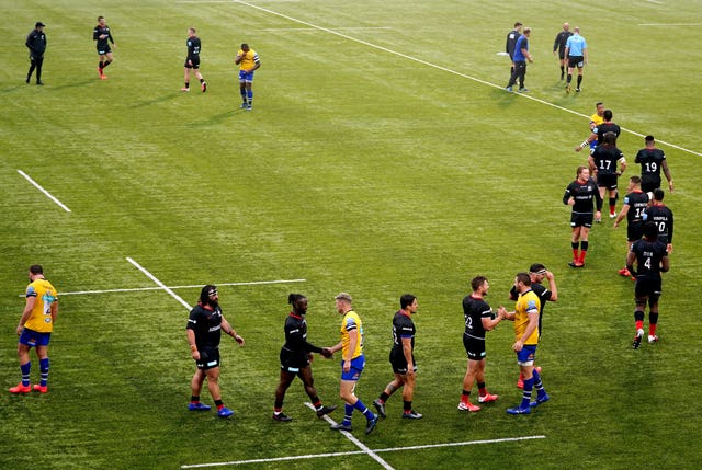Saracens and Bath players shake hands at the end of the match