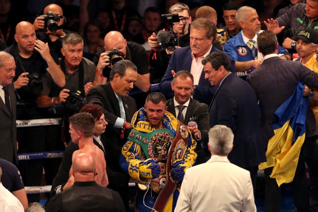 Vasyl Lomachenko (centre) added the WBC lightweight title to his WBA and WBO belts by beating Britain's Luke Campbell on points in London