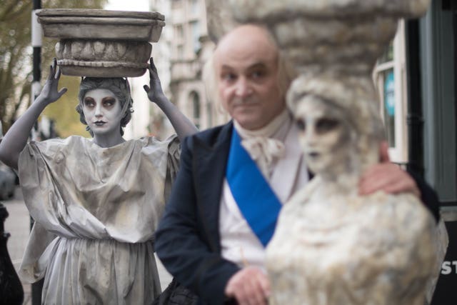 Campaigners dressed as Lord Elgin and a Parthenon Marble demonstrate outside the British Museum in London, calling for the museum to return the Parthenon Sculptures, also known as the Elgin Marbles, to Greece