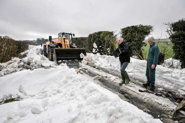 A JCB machine is deployed (Ben Birchall/PA)