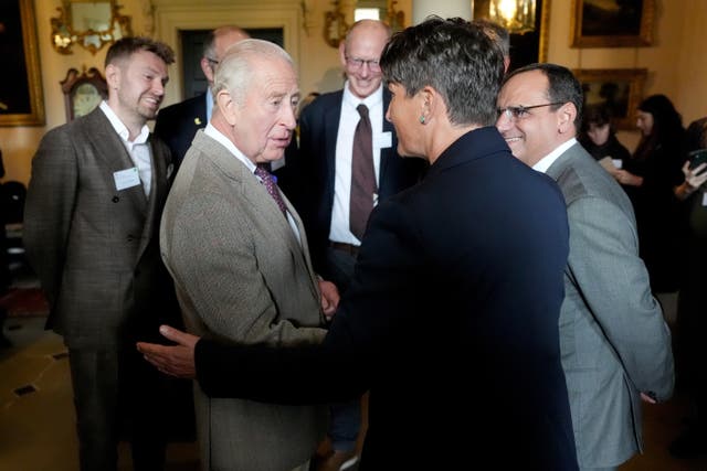 The King chatting amongst a group of people