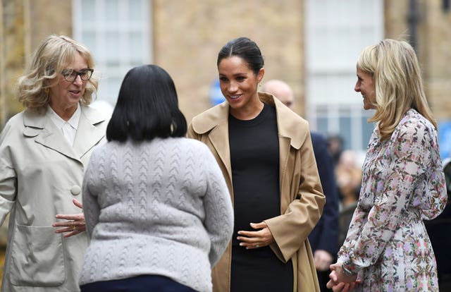 Lady Juliet Hughes-Hallett (left), chair of Smart Works, Kate Stephens (right), CEO of Smart Works, and another individual welcome Meghan. Clodagh Kilcoyne/PA Wire