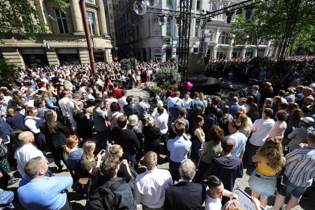 Crowds gathered in St Ann’s Square listened to the memorial service (Aaron Chown/PA)