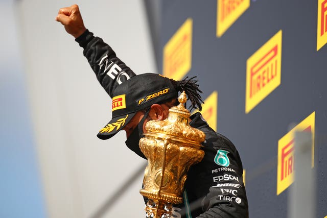 In the wake of the coronavirus pandemic, Mercedes' British driver Lewis Hamilton wears a mask as he celebrates last weekend's win. The 35-year-old claimed a dramatic seventh Silverstone success, crossing the line on three wheels following an extraordinary last-lap puncture