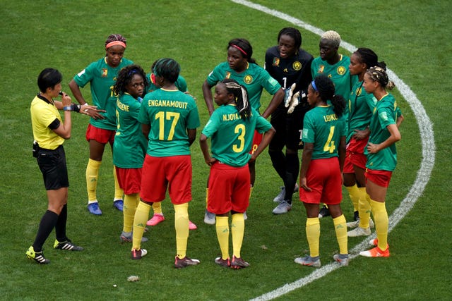 Cameroon players protest over the award of England''s second goal 