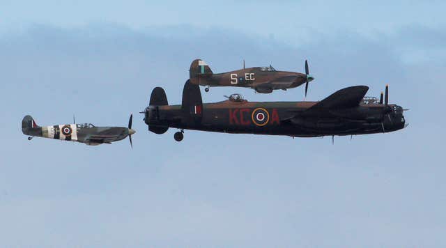 A Lancaster bomber, a Spitfire and a Hurricane in a Battle of Britain memorial flight (Peter Byrne/PA)