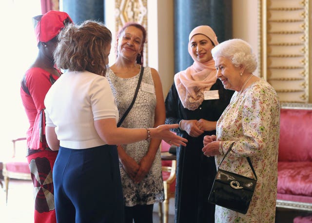 Queen Elizabeth II greets (left to right) Valentine Nkoyo, Anna Dyson, Rachael Cox, and Nighat Khan at the reception (Jonathan Brady/PA)
