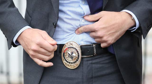 Leo Varadkar displays a belt buckle given to him by Texas governor Greg Abbott at the Governors Mansion in Austin (Niall Carson/PA)
