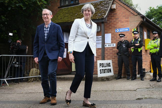 Prime Minister Theresa May and her husband Philip after casting their votes in 2017 (Stefan Rousseau/PA)