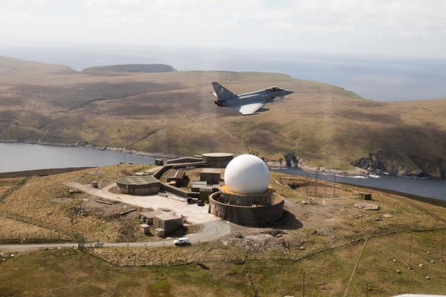 An RAF Typhoon from RAF Lossiemouth flying over the newly installed Air Defence Radar at Saxa Vord, on the Island of Unst, Shetland (Trish James/MoD/PA).