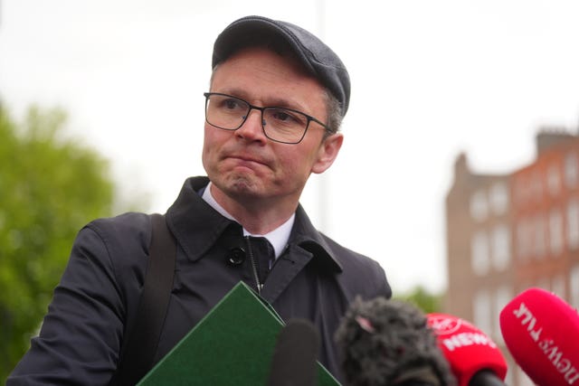 Minister for Communications Patrick O’Donovan listens to journalists