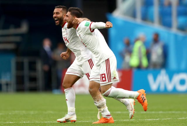 Iran’s Alireza Jahanbakhsh (front) and Saman Ghoddos celebrate after the final whistle