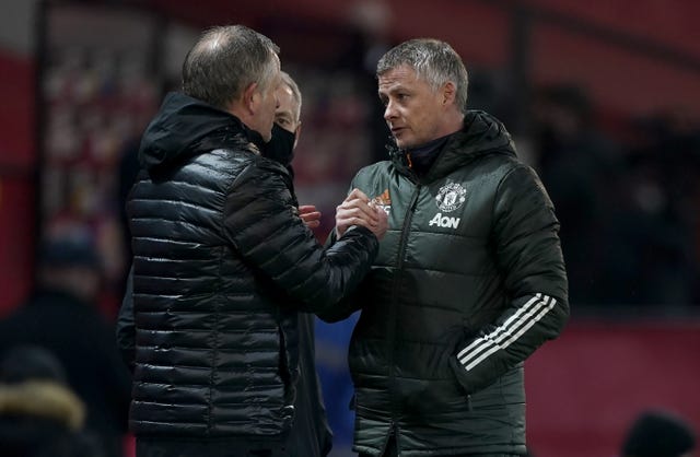 Ole Gunnar Solskjaer, right, shakes hands with Sheffield United manager Chris Wilder
