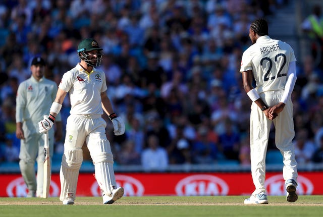 Jofra Archer, right, and Matthew Wade exchange words