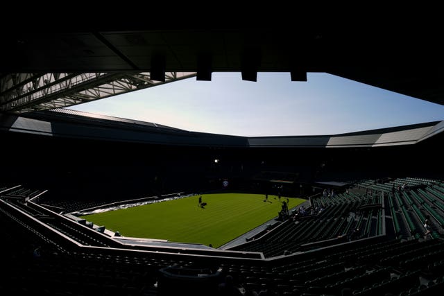 Ground staff preparing centre court on day one of the 2025 Wimbledon Championships