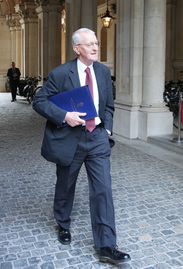 Hilary Benn walking along Downing Street