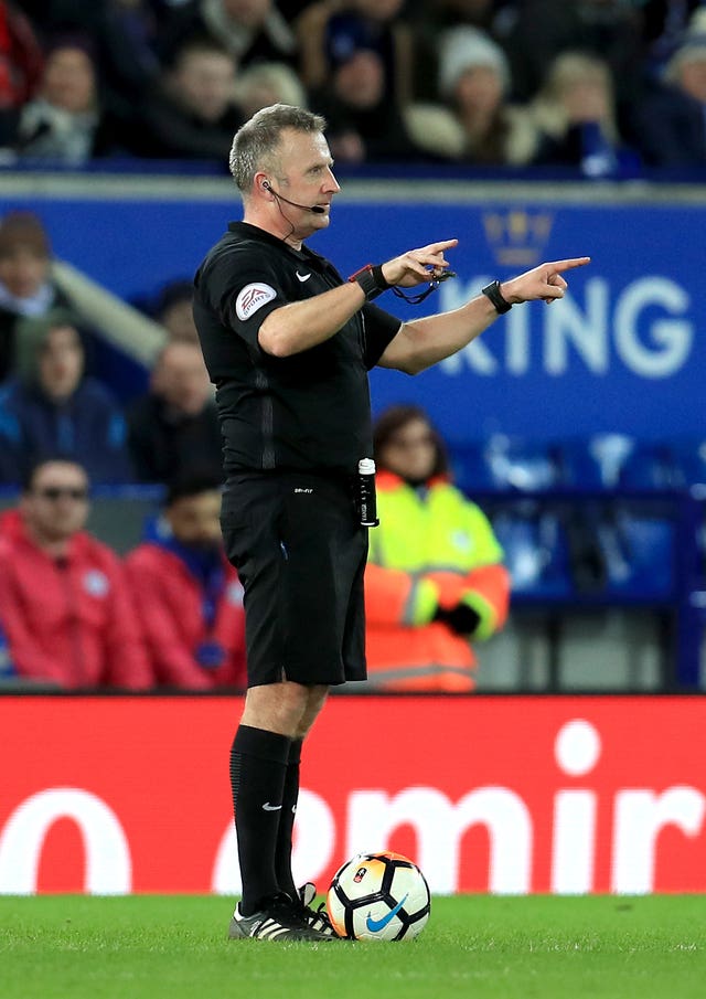 Referee Jon Moss signals for a video review