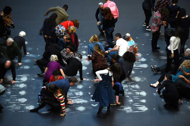 Guests get up after lying on Tania Bruguera’s artwork
