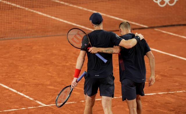 Andy Murray, left, embraces Dan Evans