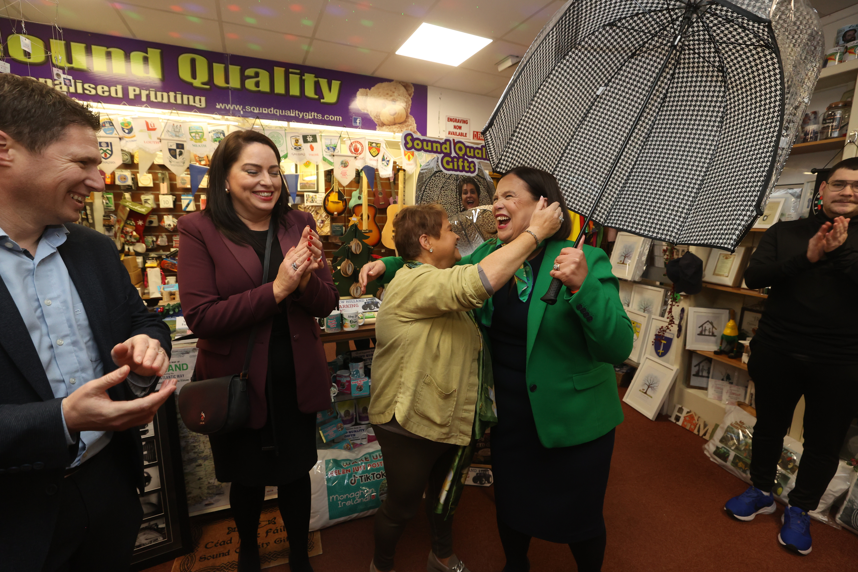 Helen Drumm gifting Mary Lou McDonald an umbrella