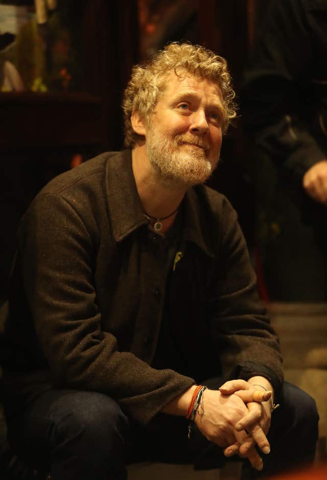 Glen Hansard takes part in the annual Christmas Eve busk in aid of the Dublin Simon Community outside the Gaiety Theatre in Dublin